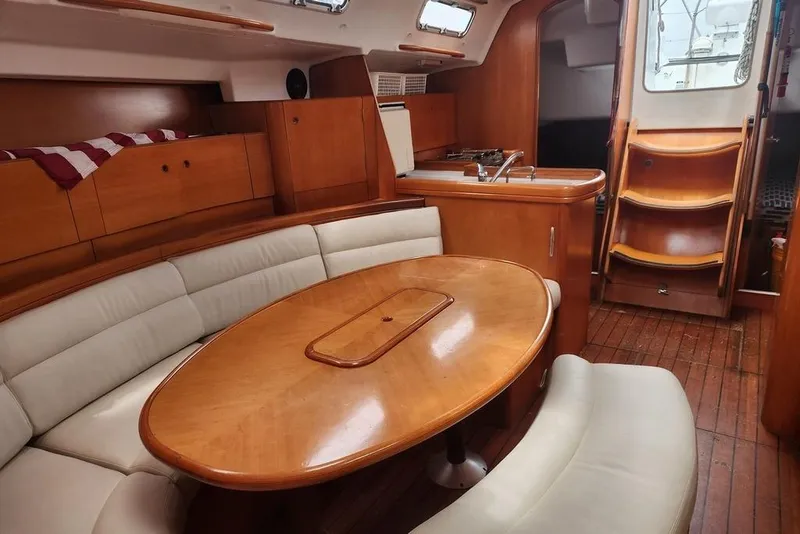 Slide: The Image of Luxurious interior of 2005 Beneteau First 44.7 yacht with wooden furnishings and cozy seating. - 20