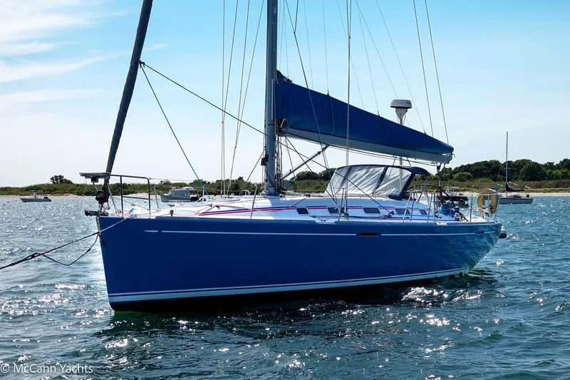 Slide: The Image of 2005 Beneteau First 44.7 sailboat on calm water, blue hull, sunny day. - 6