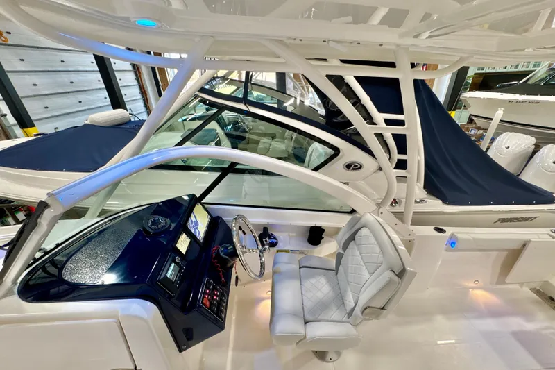 Slide: The Image of 2024 Pursuit DC 246 Dual Console boat interior with modern helm and seating. - 10
