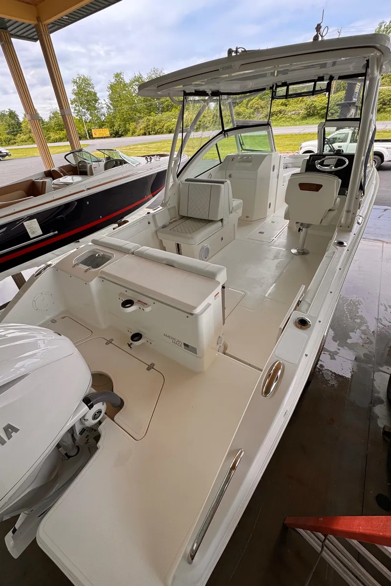 Slide: The Image of 2024 Pursuit DC 246 Dual Console boat with spacious deck and modern design. - 12