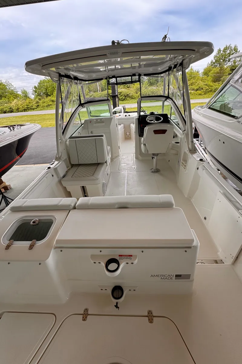 Slide: The Image of 2024 Pursuit DC 246 Dual Console boat with spacious deck and modern design. - 13