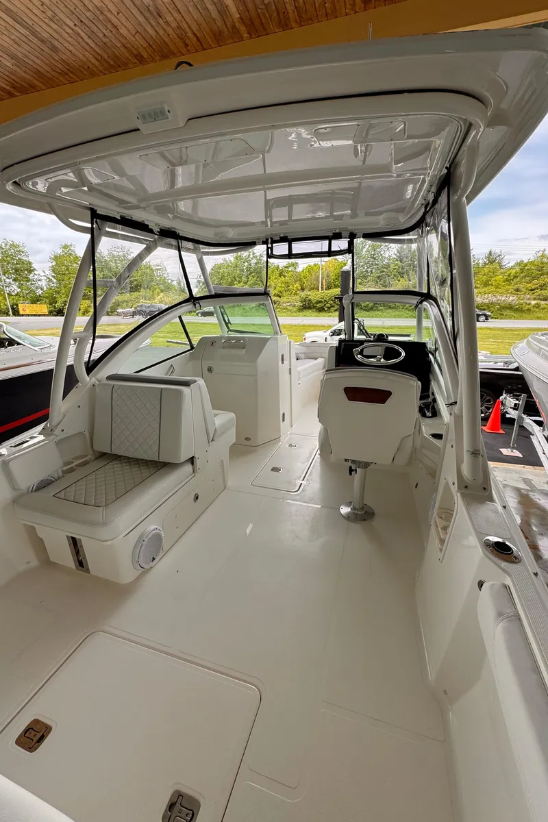 Slide: The Image of 2024 Pursuit DC 246 Dual Console boat interior with seating and helm station. - 14