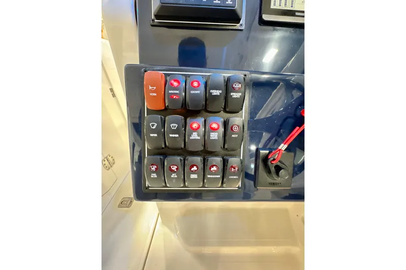 Slide: The Image of Control panel of 2024 Pursuit DC 246 Dual Console boat with labeled switches. - 20