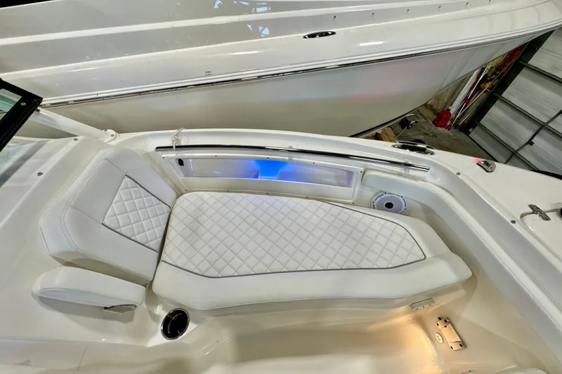 Slide: The Image of 2024 Pursuit DC 246 Dual Console boat interior with white quilted seating. - 25