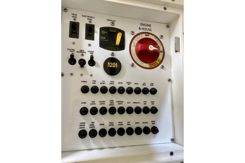 Slide: The Image of Control panel of 2024 Pursuit DC 246 Dual Console boat with switches and voltage display. - 27