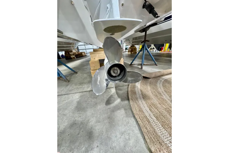 Slide: The Image of 2024 Pursuit DC 246 Dual Console boat propeller in a workshop setting. - 28