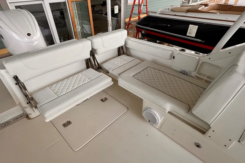 Slide: The Image of 2024 Pursuit DC 246 Dual Console boat interior with white cushioned seating. - 30