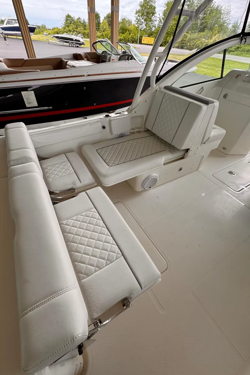 Slide: The Image of 2024 Pursuit DC 246 Dual Console boat interior with white quilted seating. - 31
