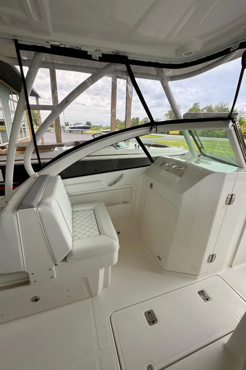 Slide: The Image of 2024 Pursuit DC 246 Dual Console boat interior with helm and seating. - 32