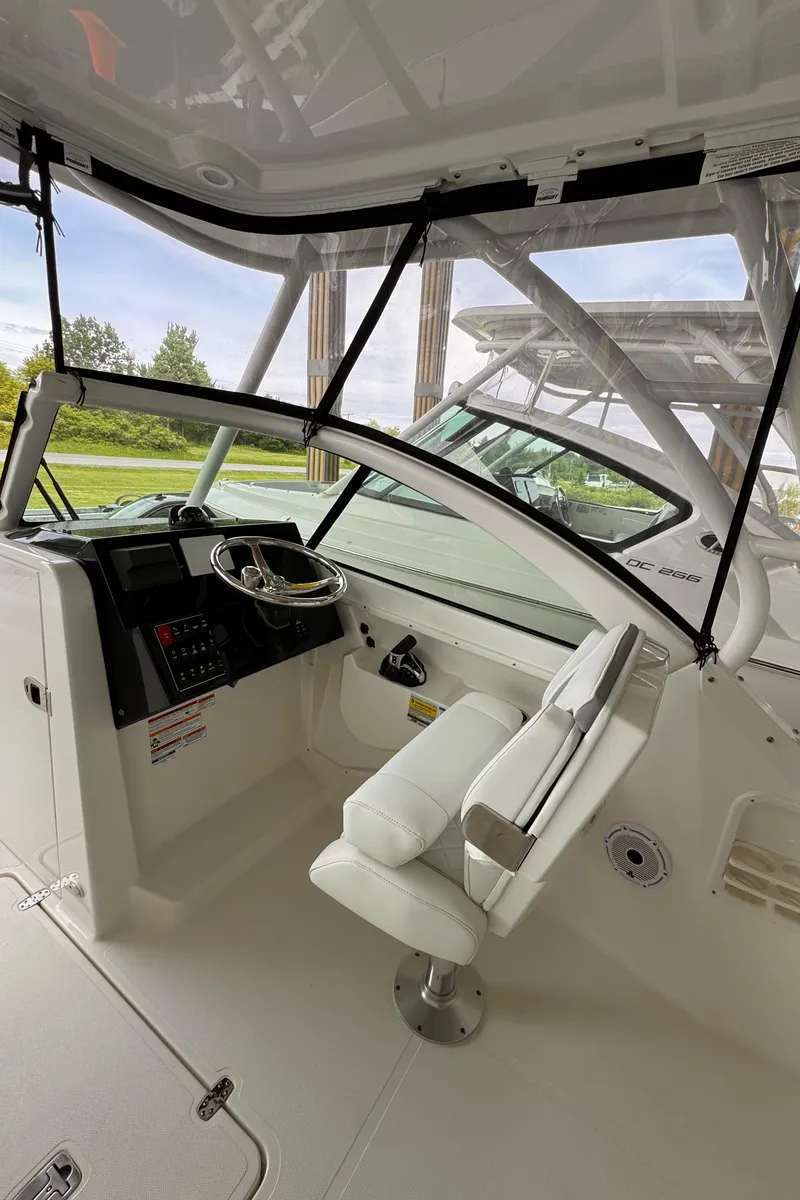 Slide: The Image of 2024 Pursuit DC 246 Dual Console boat interior with steering wheel and seating. - 33