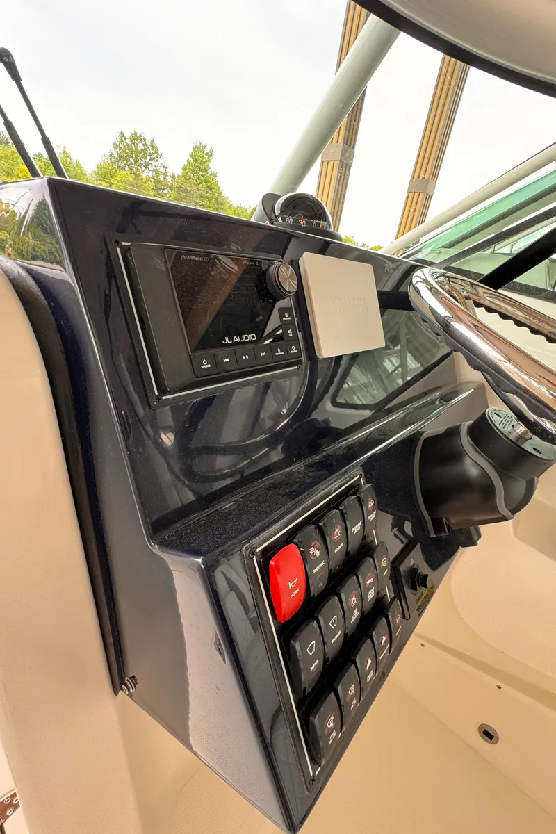 Slide: The Image of 2024 Pursuit DC 246 Dual Console dashboard with controls and steering wheel. - 36