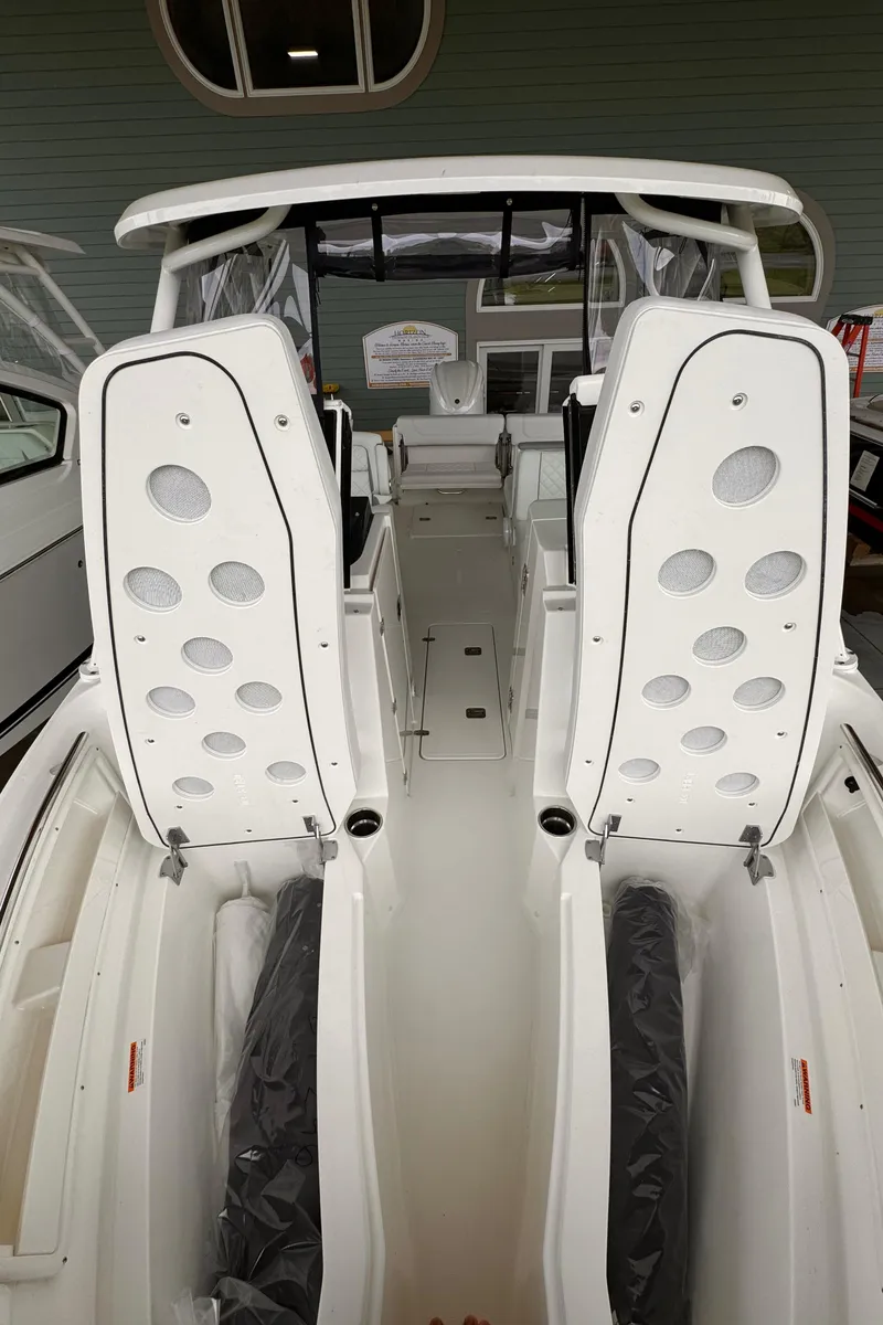 Slide: The Image of 2024 Pursuit DC 246 Dual Console boat interior with modern seating and sleek design. - 40