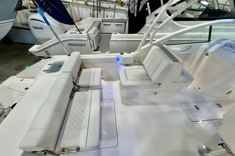 Slide: The Image of 2024 Pursuit DC 246 Dual Console boat interior with white seating and modern design. - 5