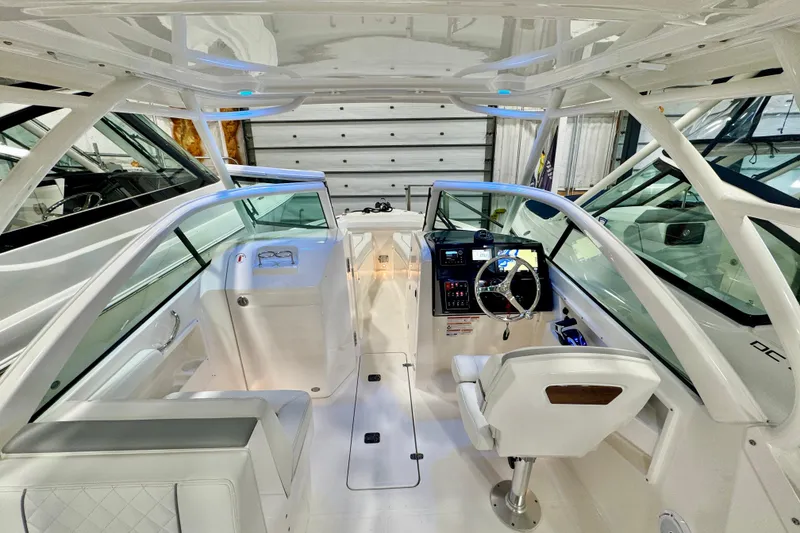 Slide: The Image of 2024 Pursuit DC 246 Dual Console boat interior with modern helm and seating. - 8