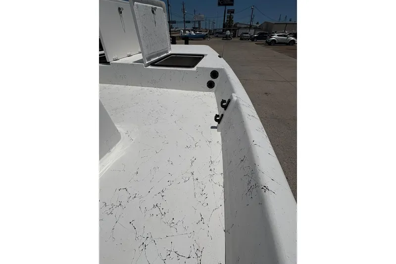 Slide: The Image of 2026 Freedom Boats 21' Commander interior with open storage compartment, white with black speckles. - 11