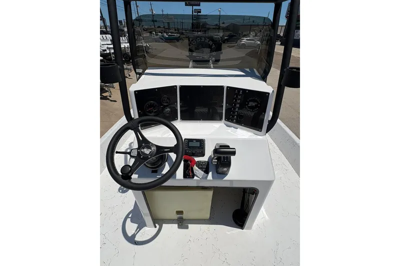 Slide: The Image of 2026 Freedom Boats 21' Commander dashboard with steering wheel and controls. - 8