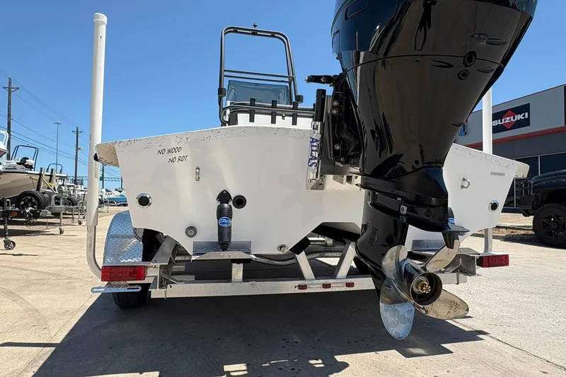 Slide: The Image of 2026 Freedom Boats 21' Commander on trailer, featuring powerful outboard motor. - 19