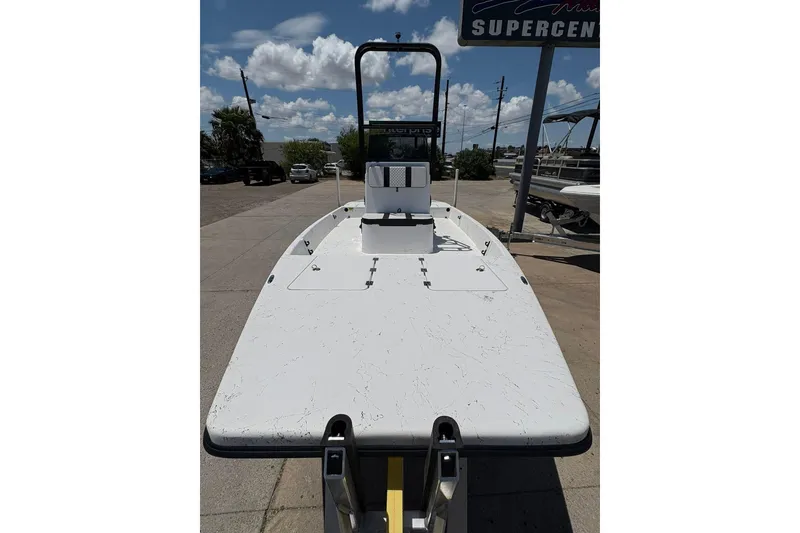 Slide: The Image of 2026 Freedom Boats 21' Commander on trailer under blue sky. - 21