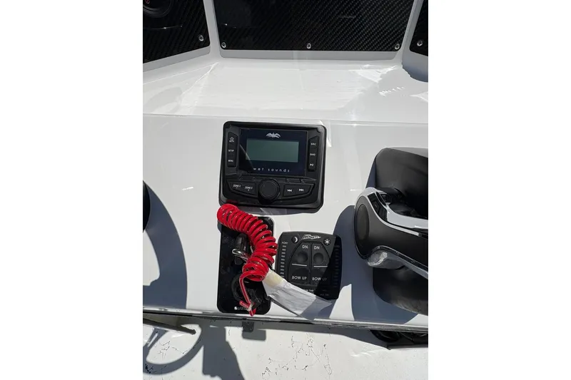 Slide: The Image of 2026 Freedom Boats 21' Commander dashboard with controls and red coiled safety lanyard. - 9