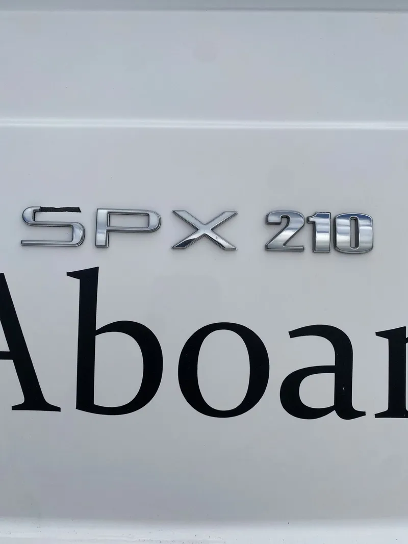 Slide: The Image of 2023 Sea Ray SPX 210 boat emblem on white surface. - 3