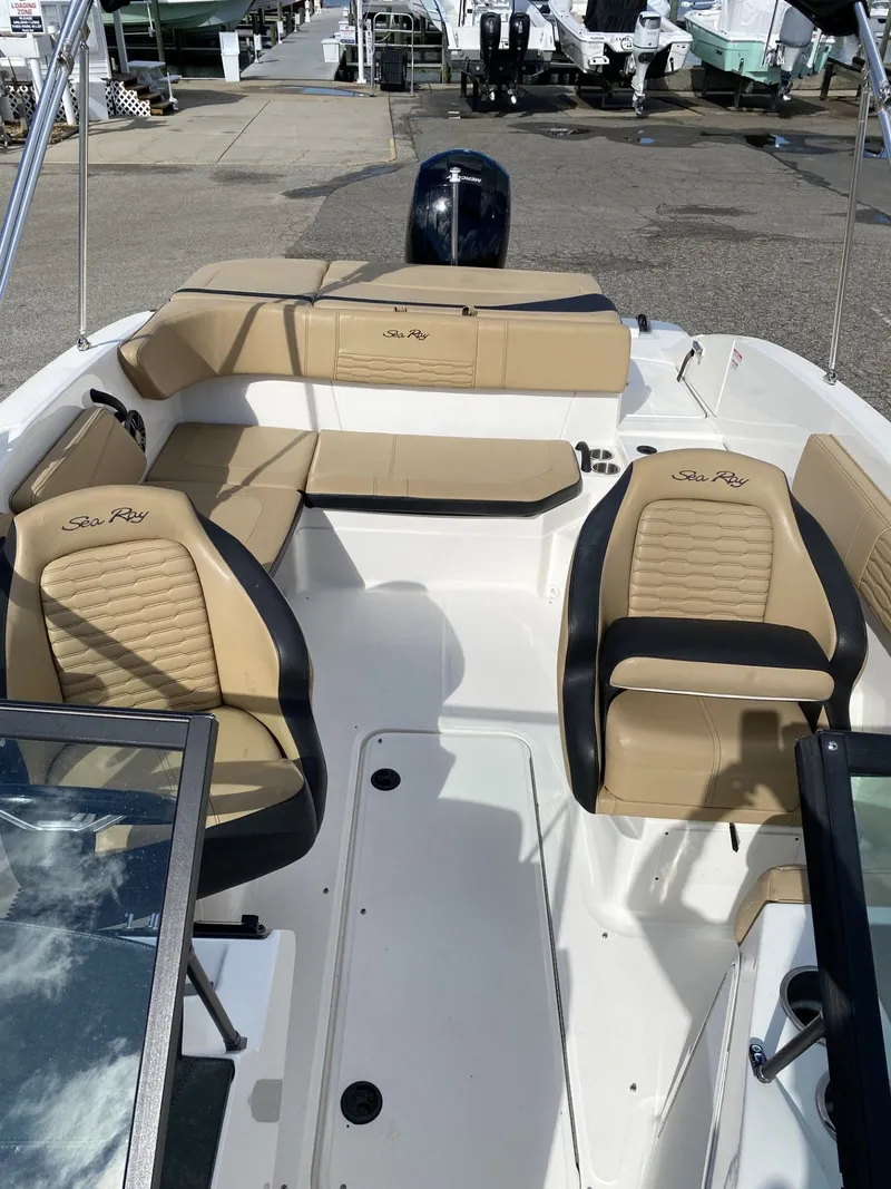Slide: The Image of 2023 Sea Ray SPX 210 boat interior with tan and black seating. - 4