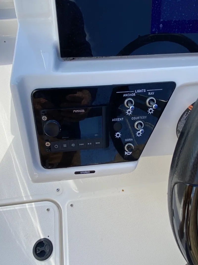 Slide: The Image of Control panel of 2023 Sea Ray SPX 210 boat with stereo and light switches. - 6