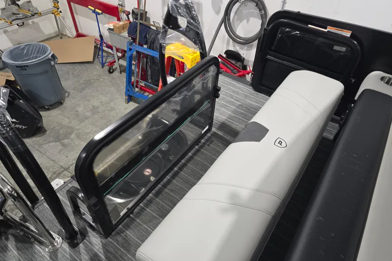 Slide: The Image of Open storage compartment in 2026 Premier 230 Intrigue GT RLO boat, revealing wiring and equipment. - 17