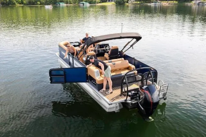 Slide: The Image of 2026 Premier 230 Intrigue GT RLO boat with ladder and powerful outboard motor. - 2