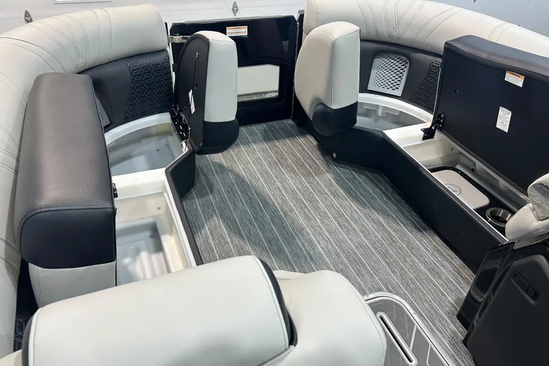 Slide: The Image of 2026 Premier 230 Intrigue GT RLO boat interior with open storage compartments and modern seating. - 28