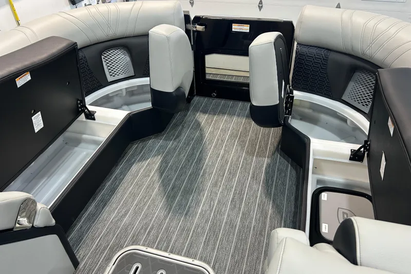 Slide: The Image of Interior of 2026 Premier 230 Intrigue GT RLO pontoon boat with open storage compartments. - 29