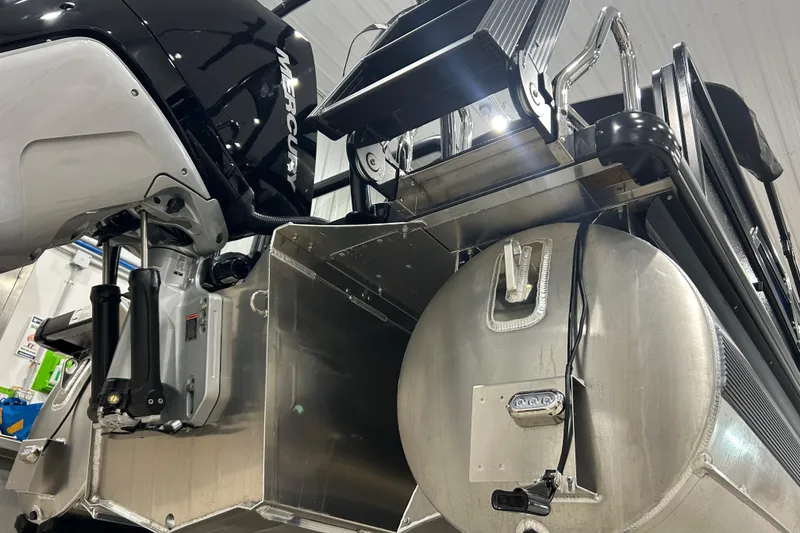 Slide: The Image of 2026 Premier 230 Intrigue GT RLO boat engine and rear view in a garage setting. - 33