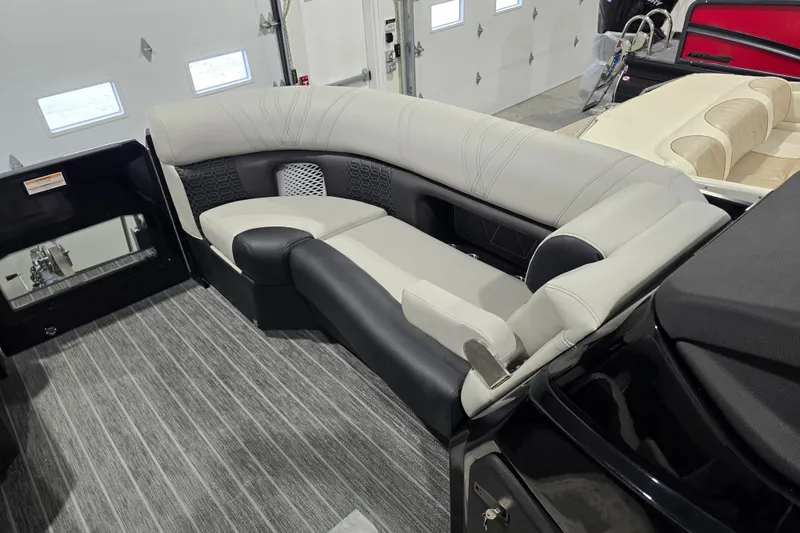 Slide: The Image of 2026 Premier 230 Intrigue GT RLO pontoon boat in a garage setting. - 8