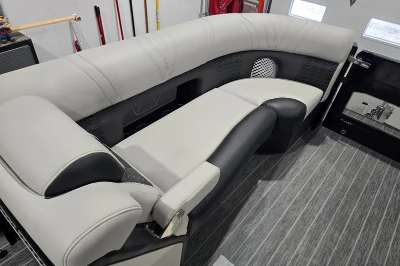 Slide: The Image of 2026 Premier 230 Intrigue GT RLO pontoon boat in a garage setting. - 9
