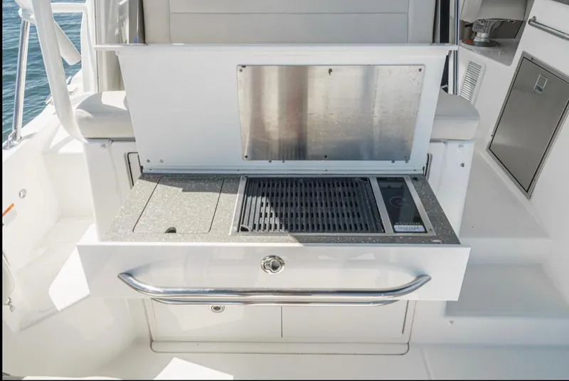 Slide: The Image of Outdoor grill station on a 2019 Boston Whaler 345 Conquest boat. - 12