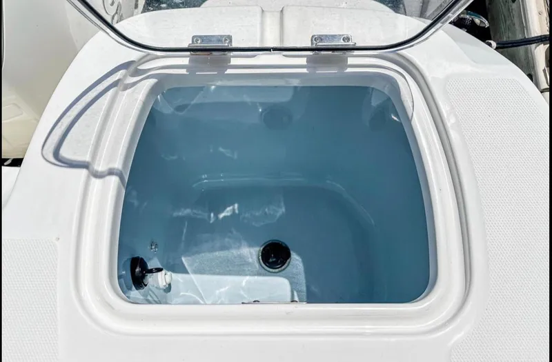 Slide: The Image of Livewell compartment on a 2019 Boston Whaler 345 Conquest boat, open lid view. - 14