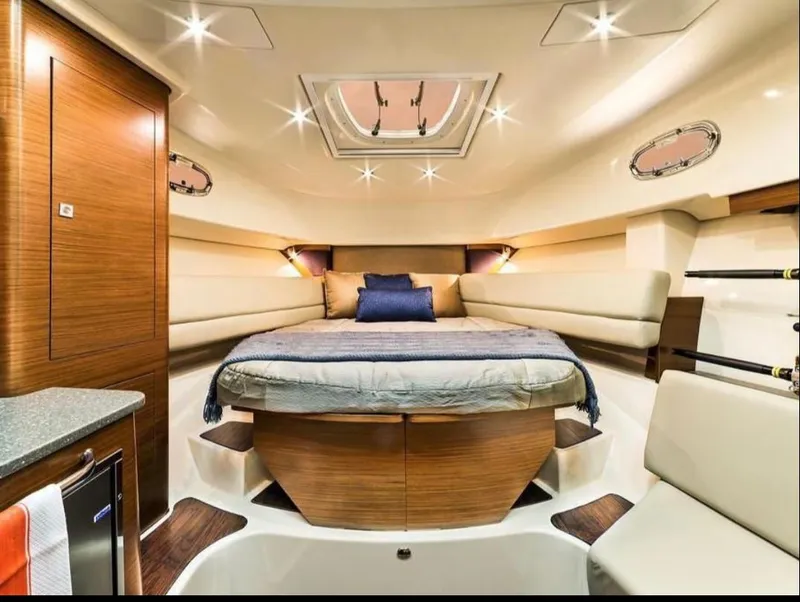 Slide: The Image of Luxurious interior of 2019 Boston Whaler 345 Conquest boat cabin with elegant wood finish. - 20