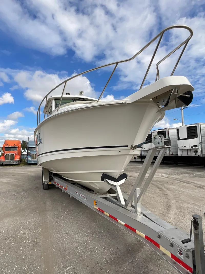 Slide: The Image of 2019 Boston Whaler 345 Conquest boat on trailer under blue sky. - 3