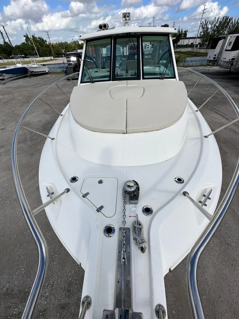 Slide: The Image of 2019 Boston Whaler 345 Conquest boat, docked, with clear skies and surrounding boats. - 7