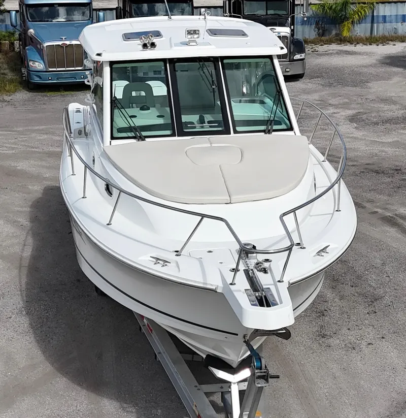 Slide: The Image of 2019 Boston Whaler 345 Conquest boat on trailer, parked outdoors. - 8