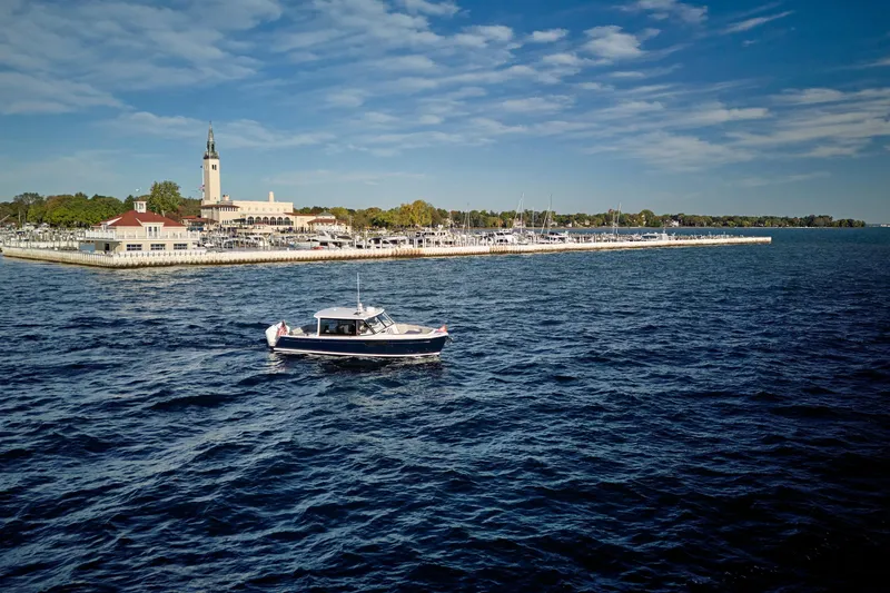 Slide: The Image of MJM 38x boat cruising near marina, clear sky, 2026 model. - 21