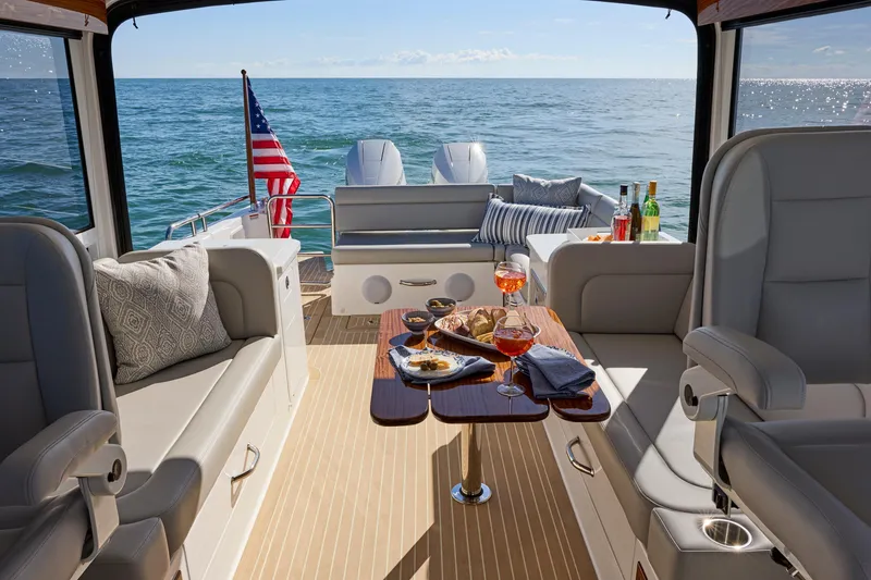 Slide: The Image of Luxurious MJM 38x yacht interior with elegant seating, table setting, and ocean view, 2026 model. - 4