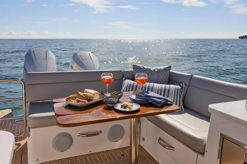 Slide: The Image of Luxurious MJM 38x yacht interior with dining setup, ocean view, and twin engines, 2026 model. - 9