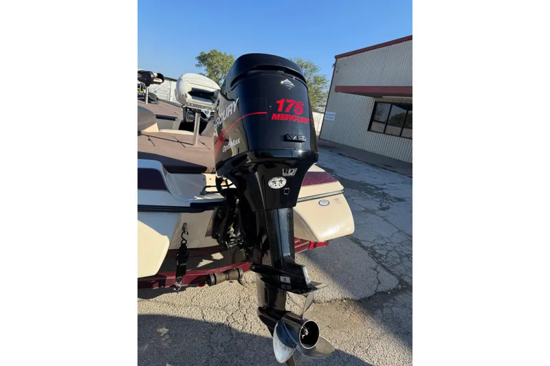 Slide: The Image of 2006 Skeeter SX200 boat with Mercury 175 outboard motor in a parking lot. - 7