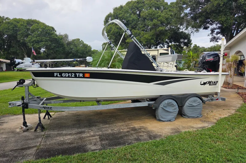 The Image of 2023 Mako Pro Skiff 19 CC boat on trailer, parked in residential driveway. - 0