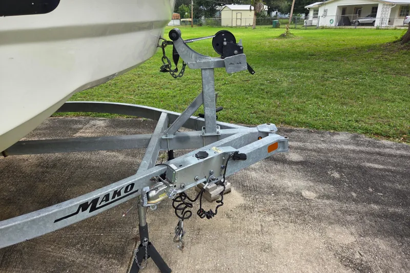 Slide: The Image of Trailer hitch of 2023 Mako Pro Skiff 19 CC boat on concrete driveway. - 13