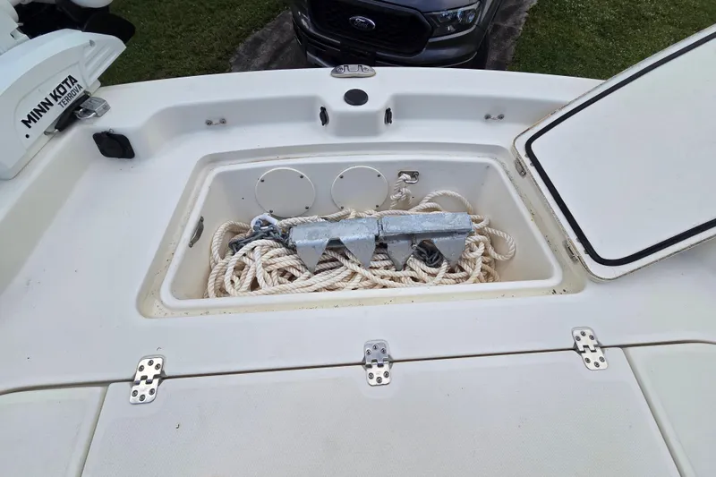 Slide: The Image of 2023 Mako Pro Skiff 19 CC anchor storage with rope and Minn Kota motor. - 17