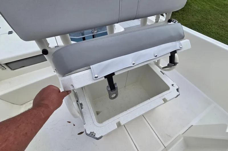 Slide: The Image of 2023 Mako Pro Skiff 19 CC seat storage compartment being opened. - 22