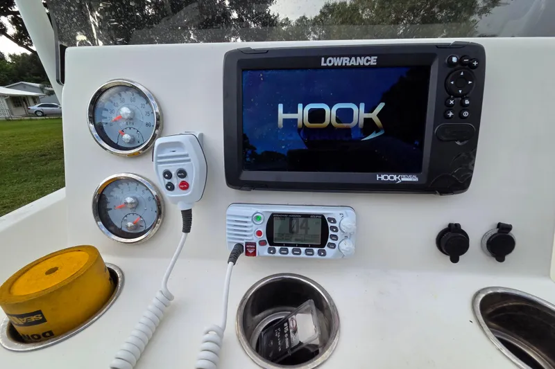 Slide: The Image of 2023 Mako Pro Skiff 19 CC dashboard with Lowrance Hook display and gauges. - 23