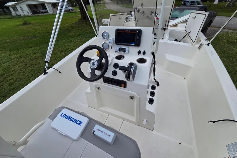 Slide: The Image of 2023 Mako Pro Skiff 19 CC boat interior with steering console and navigation equipment. - 24