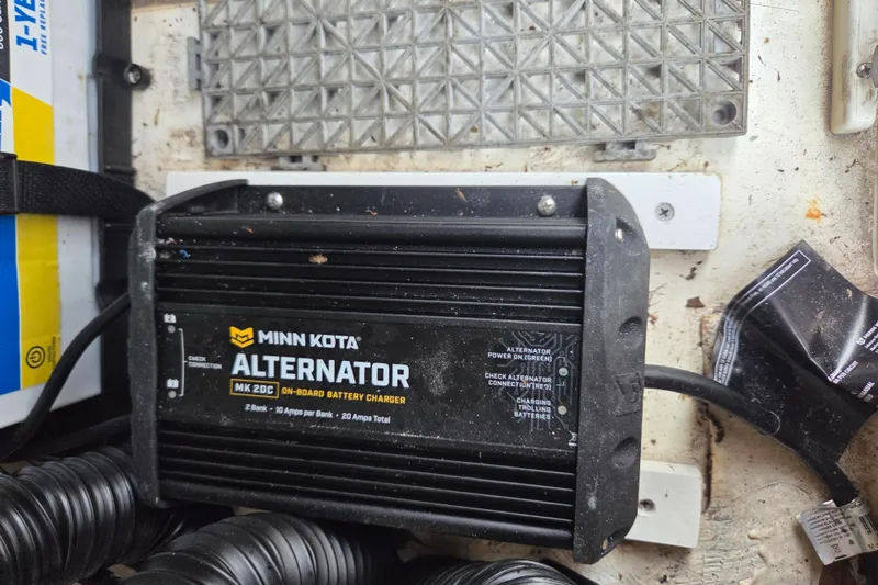Slide: The Image of Minn Kota alternator on-board battery charger in 2023 Mako Pro Skiff 19 CC boat. - 26